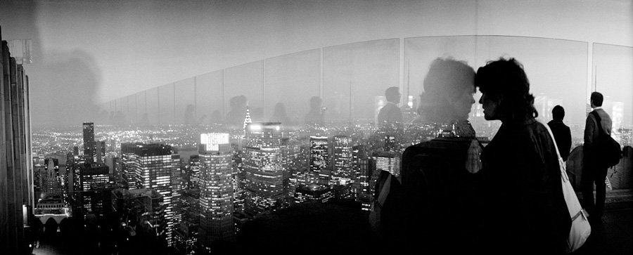 The Invisible City: Woman look at the city at night from the roof of the Rockfeller Center, New York, April 2010. (Photo by Viviana Peretti)