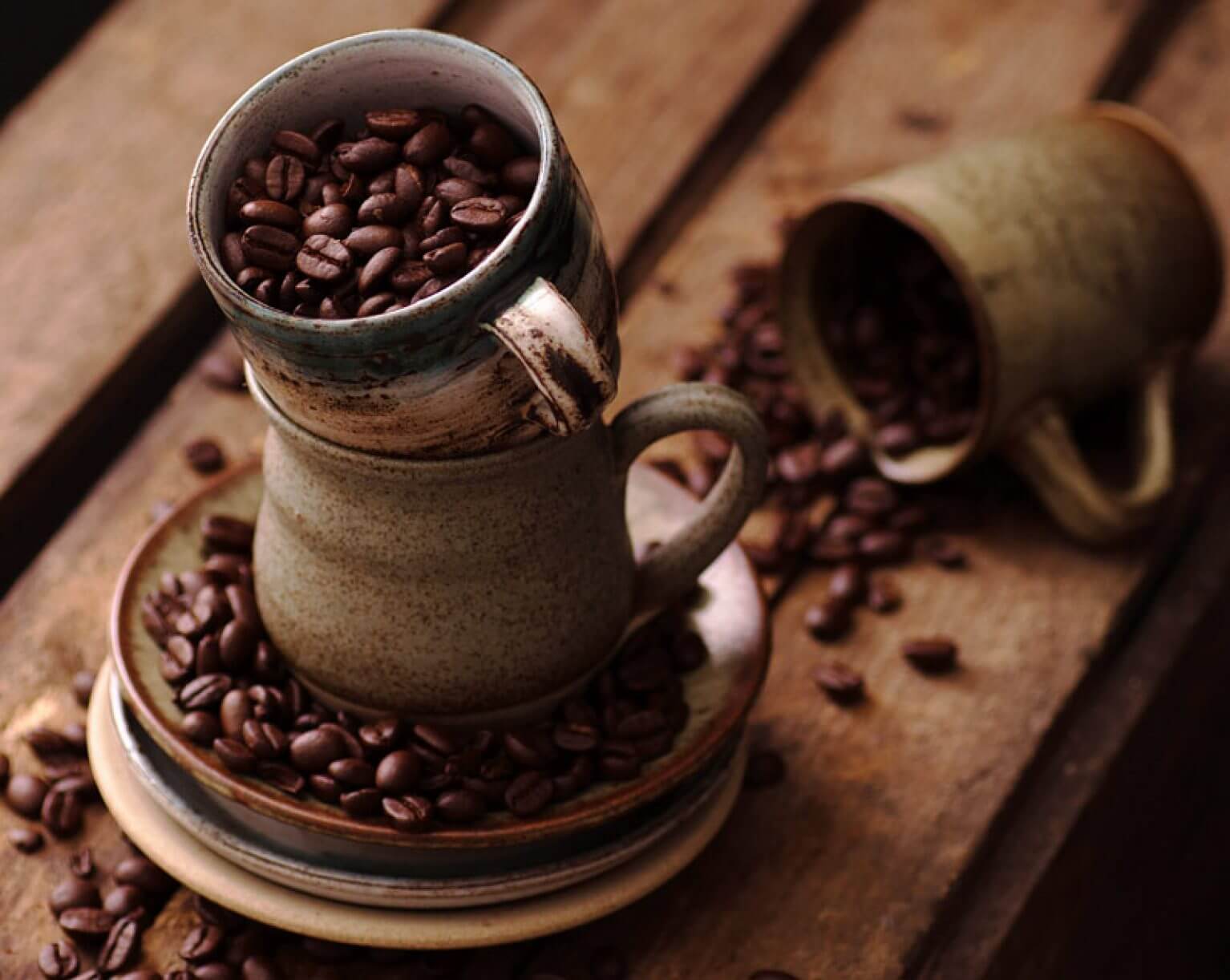 picture of coffee beans overflowing in a coffee mug